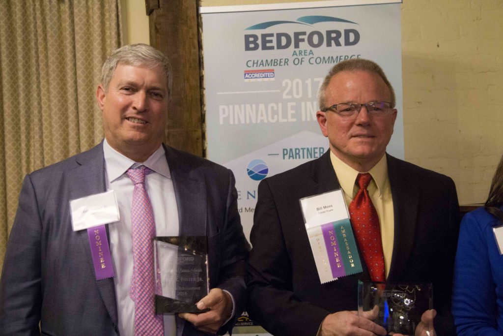 Watt Foster, CEO and President of Foster Fuels, stands next to Bill Moss both holding Bedford Area Chamber of Commerce awards.